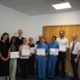 Hospital workers stood on a stage, holding certificates