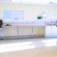 Image shows a person standing in a large empty room.