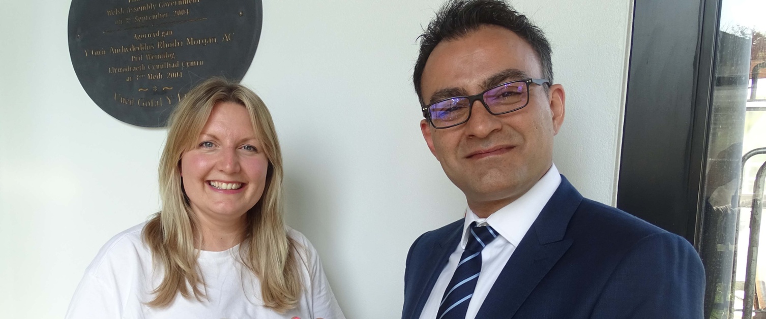 Image shows two people smiling into the camera.