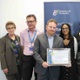 A group of clinicians and laboratory staff with their award certificate
