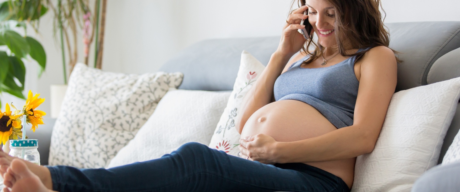 a pregnant woman on the phone