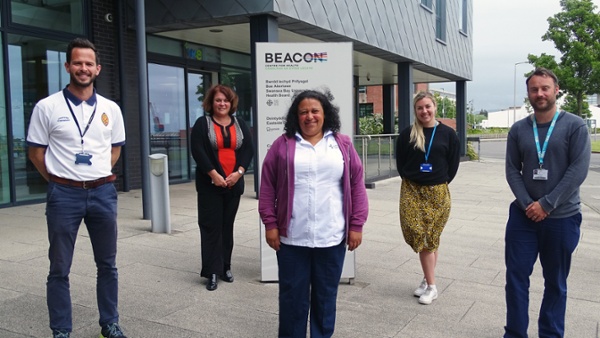 Five people standing outside a health centre