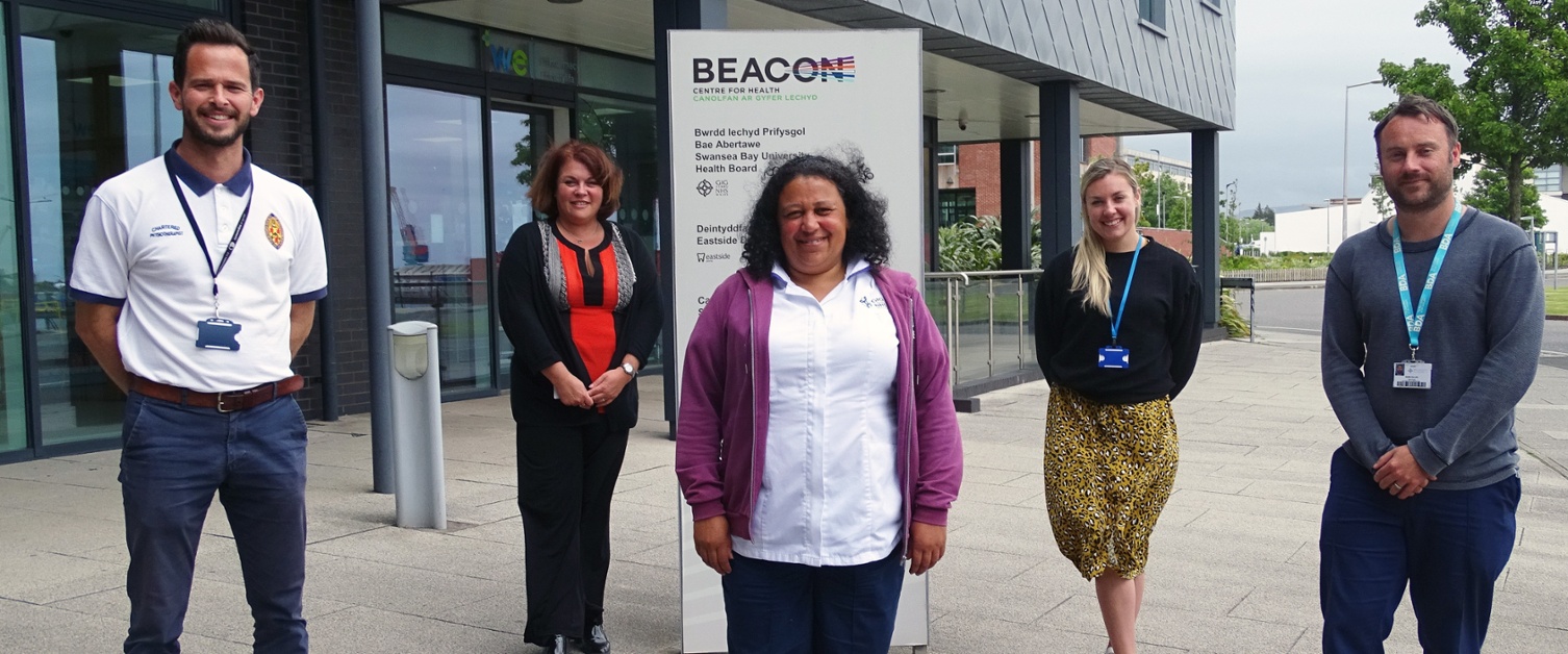Five people standing outside a health centre