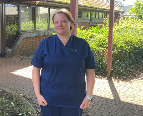 Laura stood outside a GP practice