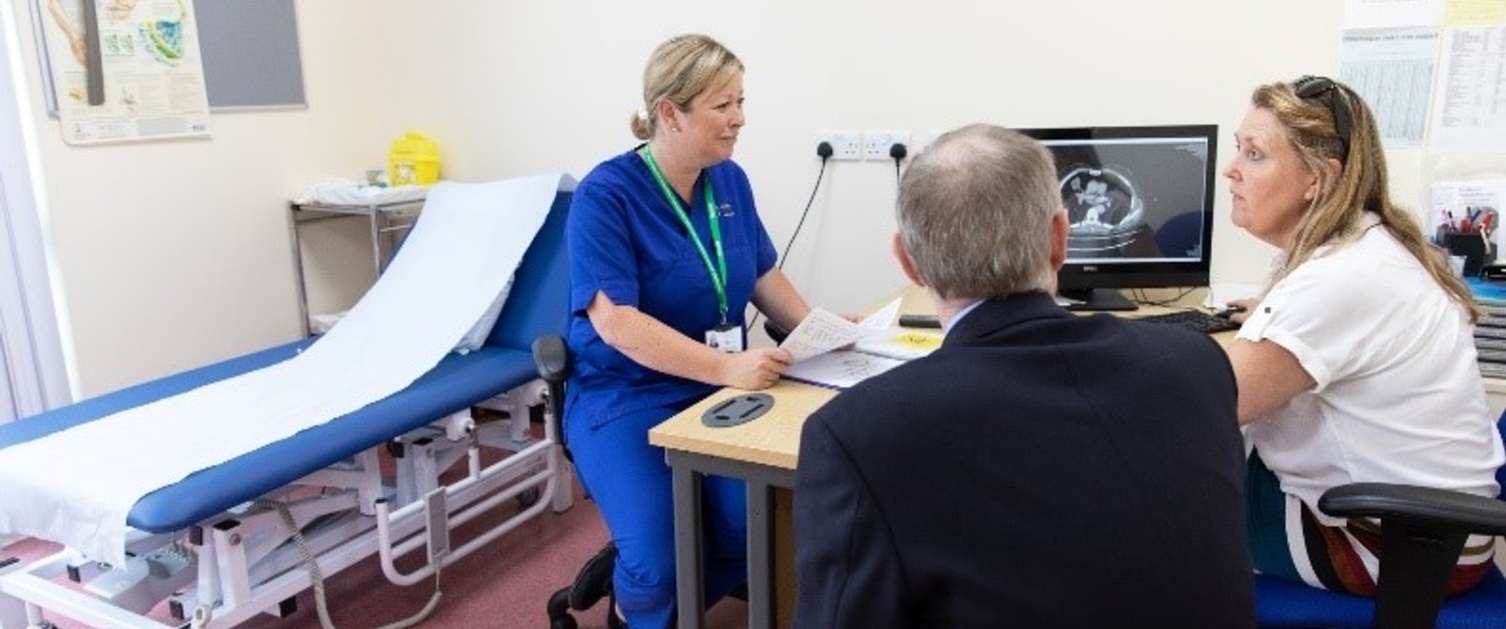 An image of patients talking to a nurse