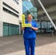 Tracy holding her award outside a building