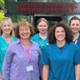 Image shows a group of clinical staff standing in front of an Emergency Department
