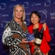 Image shows two people at an awards ceremony.