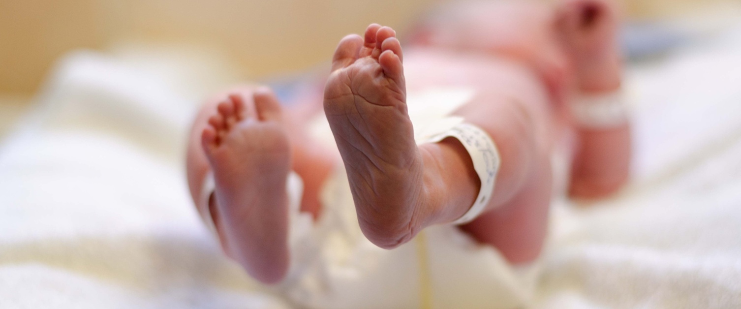 Image shows feet of a tiny baby being cared for in a neonatal unit.