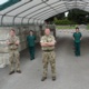 Four soliders are pictured standing socially distanced with three health care support workers.