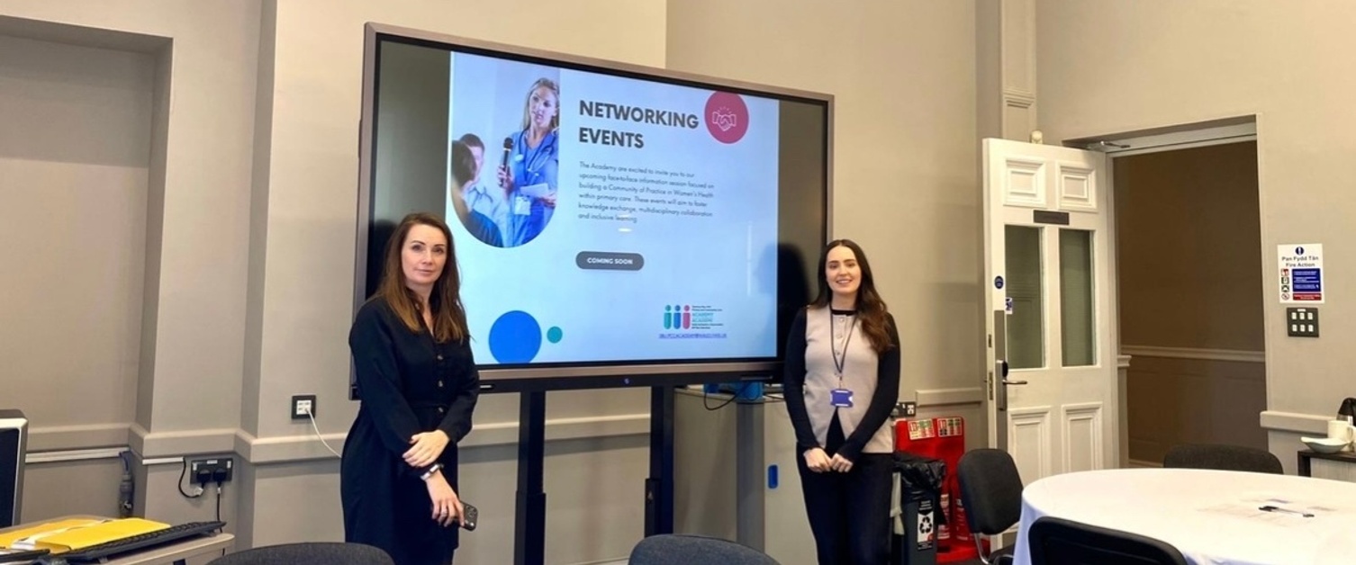 Rhian and Jess stood next to a TV screen