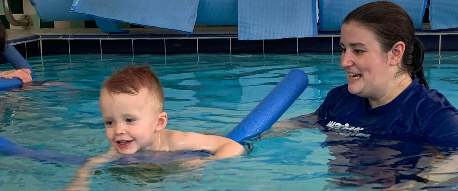 Image shows a woman and baby in a pool