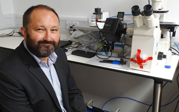 Image shows a clinician looking into the camera.