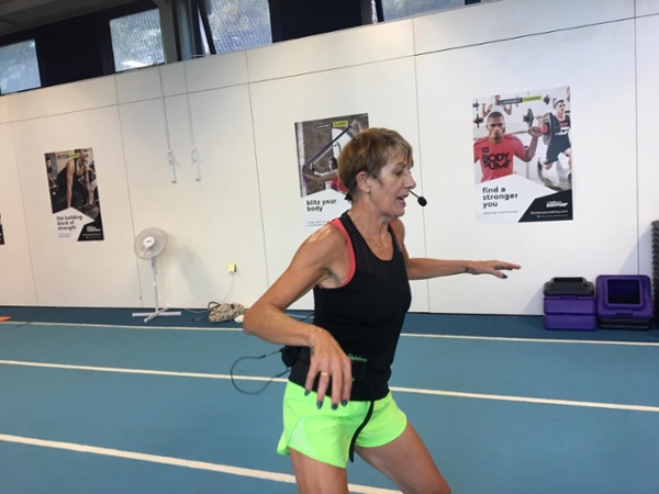 A woman hosting a fitness class