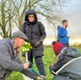 Image shows people gardening in a field