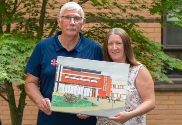 Two people holding a painting