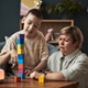 A young boy with additional needs stacks coloured blocks