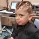 This composite photo shows the mobile tablet camera on a tripod, along with the EEG attached to a mannequin head. These are alongside the range of colourful rucksacks children can use to carry their EEG around. Also pictured is patient Jack Pawlowski.