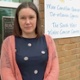 Image shows a staff member outside a hospital building