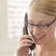 A woman smiling and talking on the phone