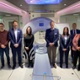 Image shows a group of people standing either side of a medical scanner