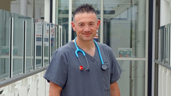 Image shows a nurse in a hospital atrium.