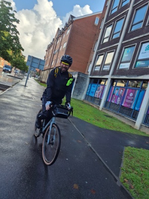 Image shows a man on a bicycle
