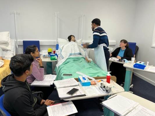 Image shows nurses training with a mannequin