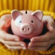 a woman holding a piggy bank