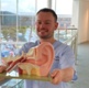 Image shows man holding a 3D ear diagram.