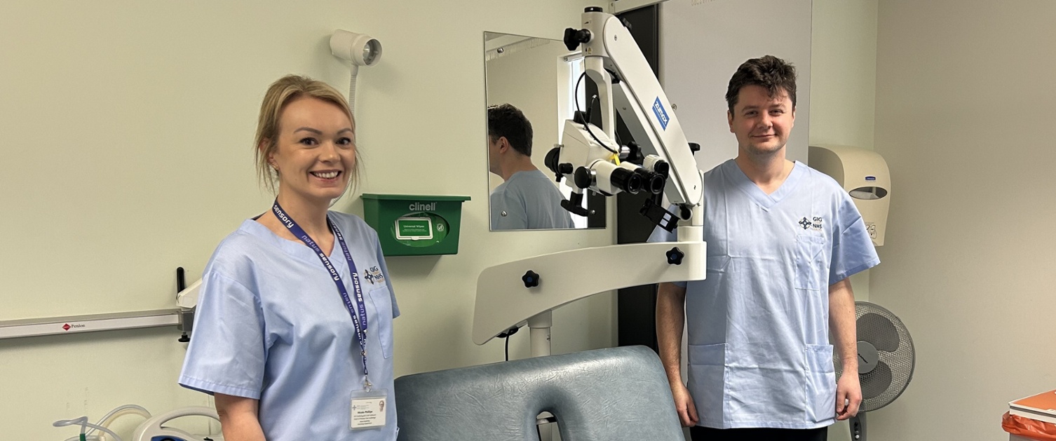 Nicola and Timothy stood either side of the microscope