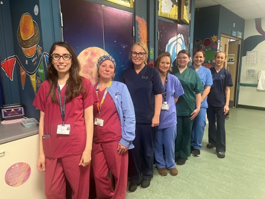Image shows a group of women standing in a line