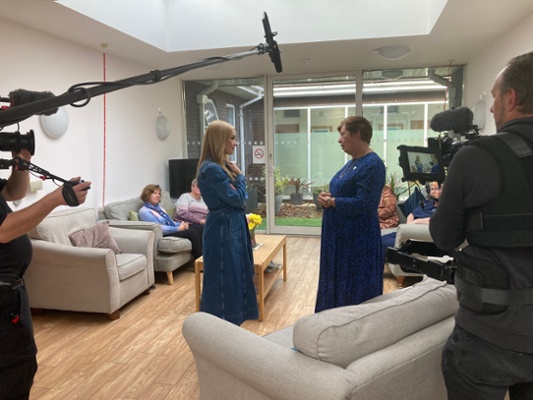 Image shows two women talking while being filmed