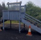 A delapidated wooden slide in a playground