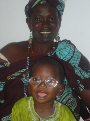 An image of two people from Gambia smiling at the camera