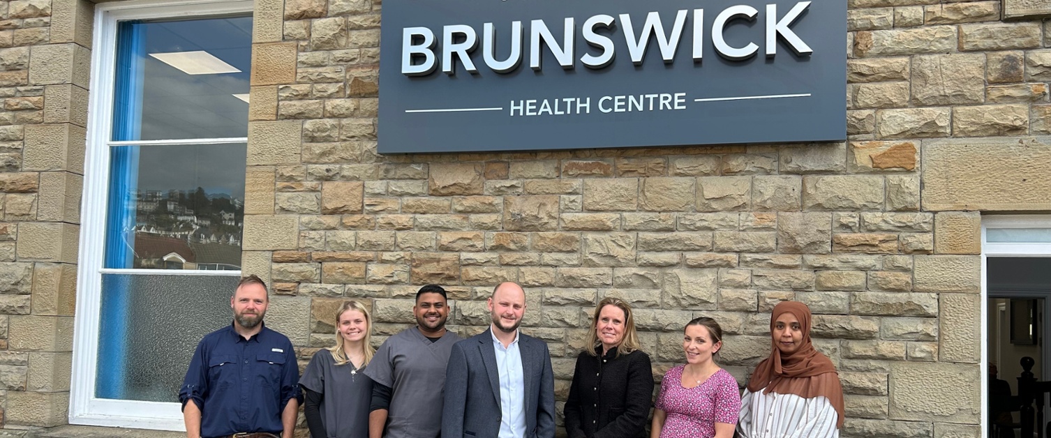 Members of staff stood outside the practice