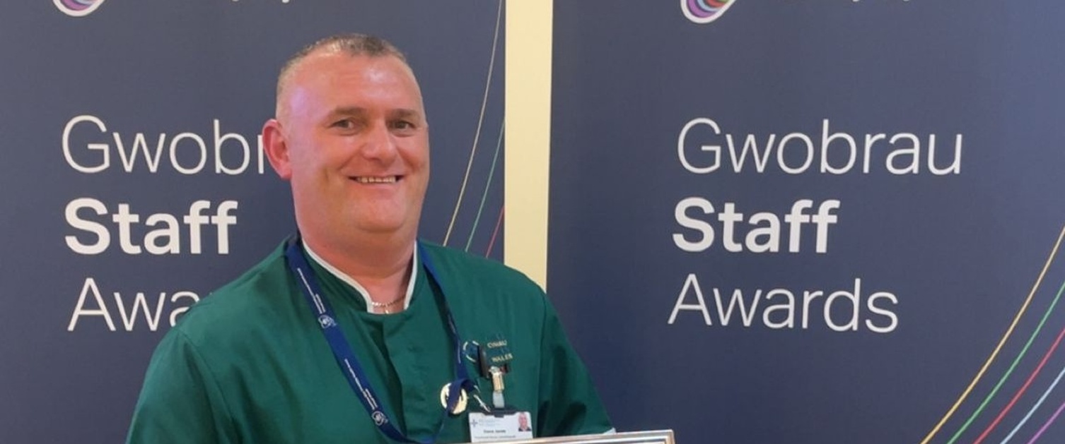 Steve wearing his uniform and holding his award certificate