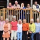 Image shows a group of people outside a pavillion.