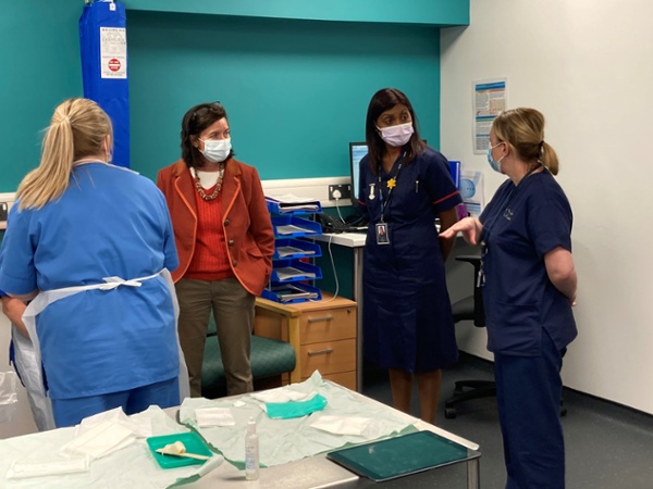 Eluned Morgan and Sue Tranka chatting with staff inside the hospital