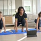 Image shows a women and children doing Pilates.