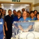 The NICU team pictured with a neonatal incubator