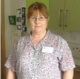 A neonatal receptionist/ward clerk smiling at the camera