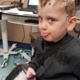 Young patient Jack Pawlowski pokes his tongue out shortly after the mobile EEG sensors have been attached to his head