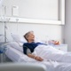 An image of a patient laying in a hospital bed, with equipment around them.