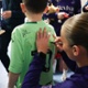 Image shows a women signing a child