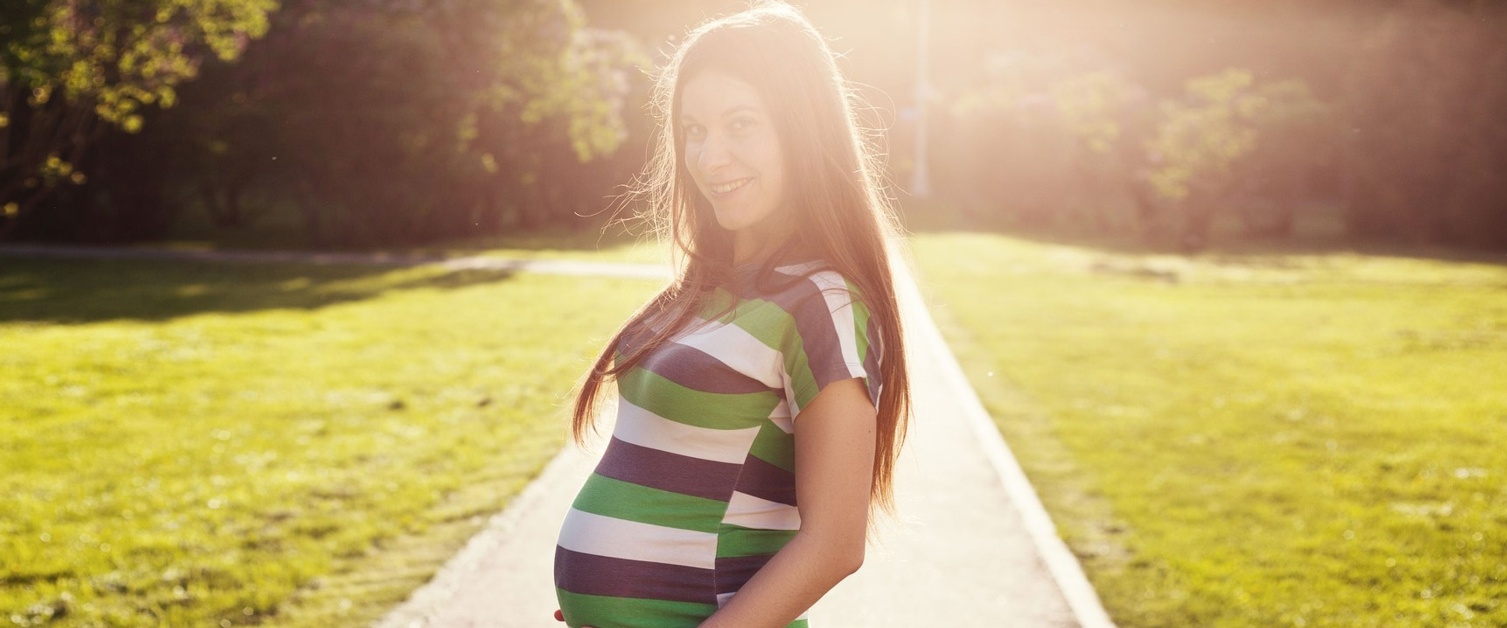 A happy pregnant woman outdoors