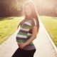 A happy pregnant woman outdoors
