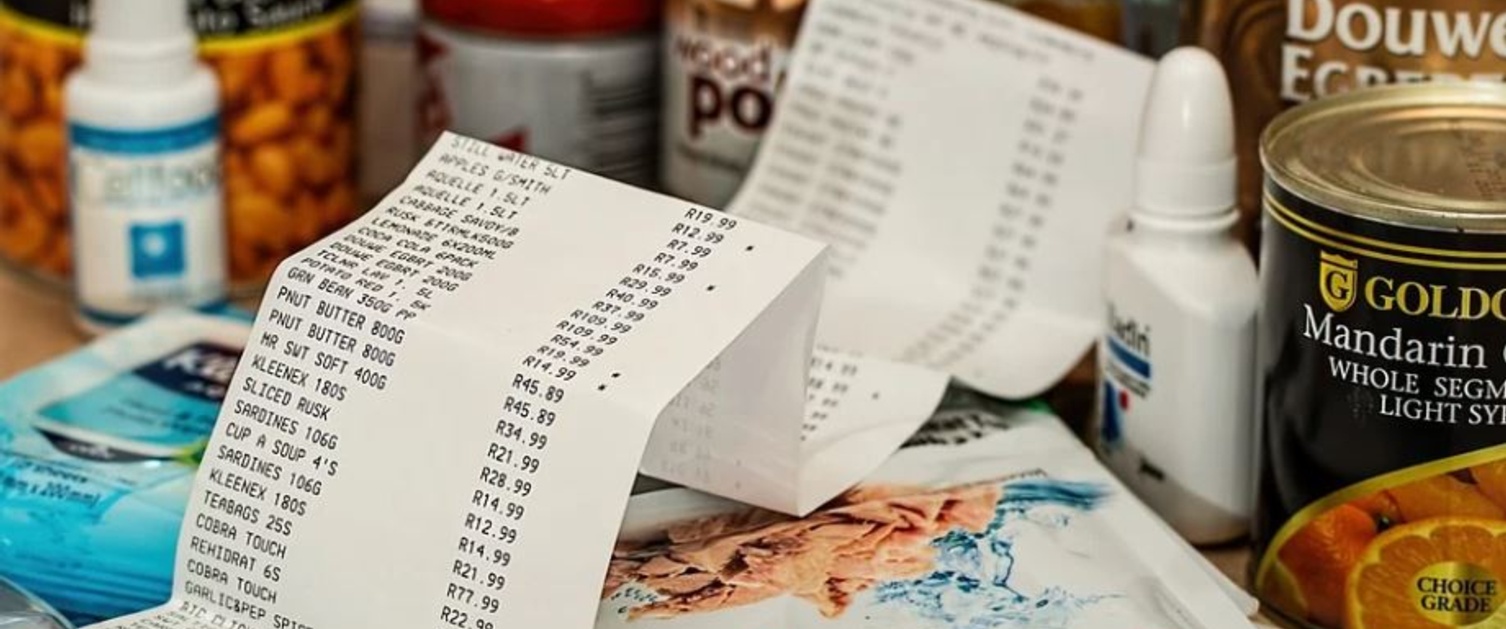 A receipt lies on top of a pile of shopping.