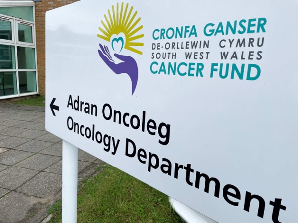 Image shows a sign for the South West Wales Cancer Centre