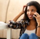 Image shows a woman chatting on a mobile phone and smiling.